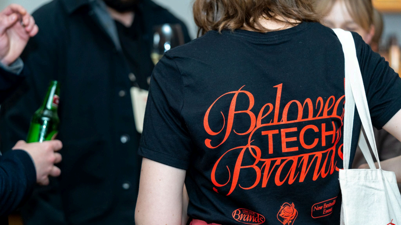 Attendee at the Beloved Tech Brands conference wearing a branded t-shirt